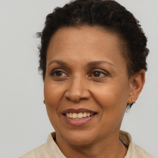 Joyful black adult female with short  brown hair and brown eyes
