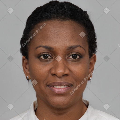 Joyful black adult female with short  brown hair and brown eyes