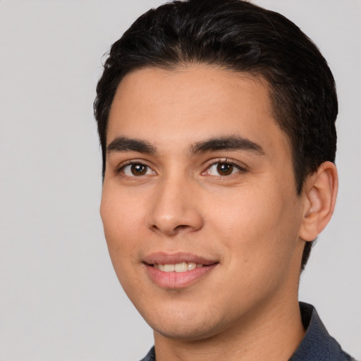 Joyful white young-adult male with short  black hair and brown eyes