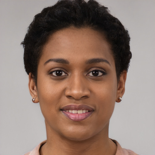 Joyful black young-adult female with short  brown hair and brown eyes