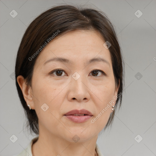 Joyful white adult female with medium  brown hair and brown eyes