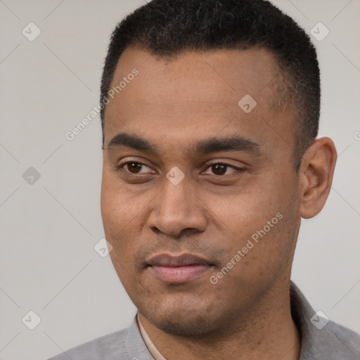 Joyful latino young-adult male with short  black hair and brown eyes