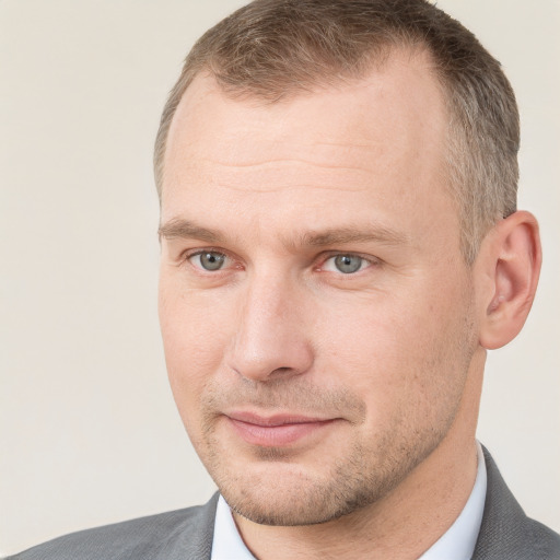 Joyful white adult male with short  brown hair and grey eyes