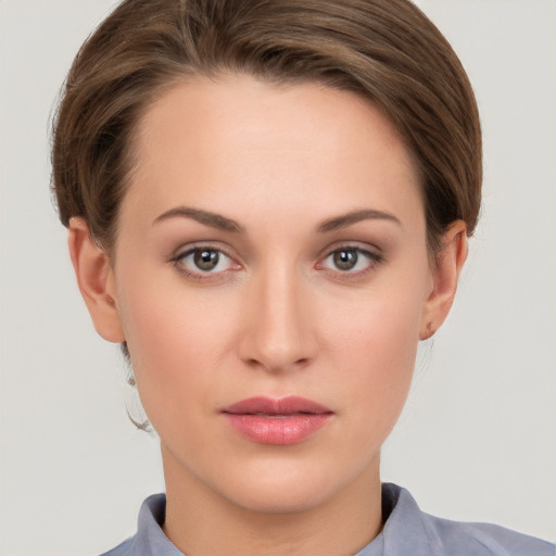 Joyful white young-adult female with short  brown hair and grey eyes