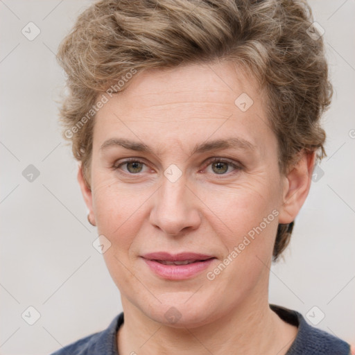 Joyful white adult female with short  brown hair and grey eyes