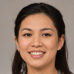 Joyful asian young-adult female with long  brown hair and brown eyes