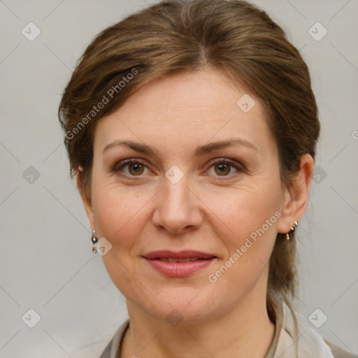 Joyful white adult female with medium  brown hair and grey eyes