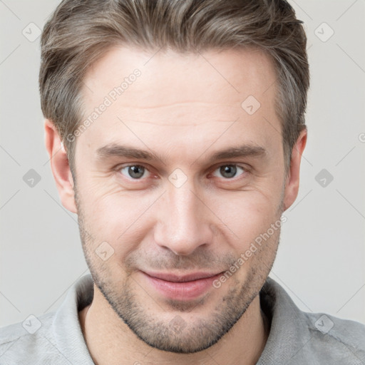 Joyful white adult male with short  brown hair and grey eyes