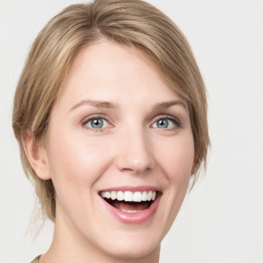 Joyful white young-adult female with medium  brown hair and green eyes