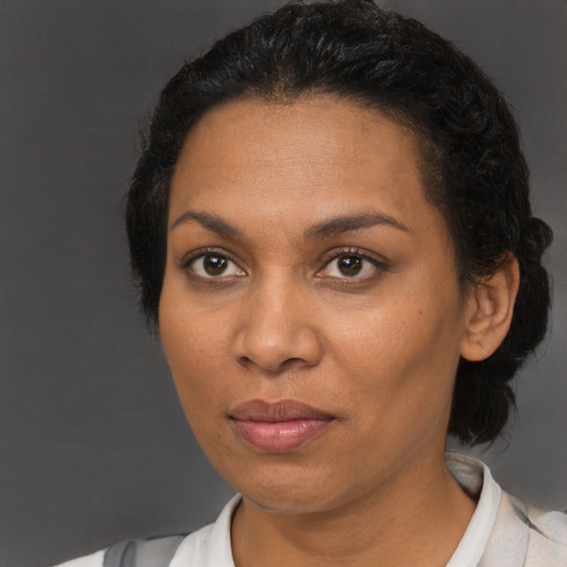 Joyful black adult female with short  brown hair and brown eyes