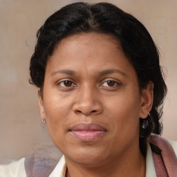 Joyful latino adult female with medium  brown hair and brown eyes