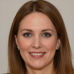 Joyful white young-adult female with long  brown hair and brown eyes