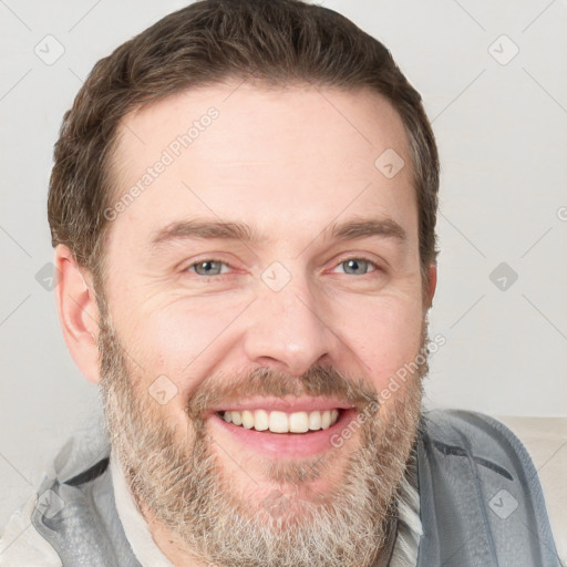 Joyful white adult male with short  brown hair and grey eyes