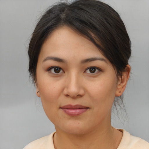 Joyful asian young-adult female with medium  brown hair and brown eyes