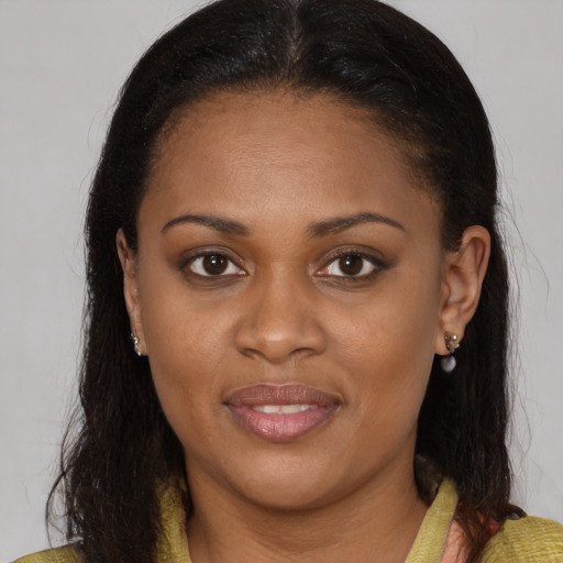 Joyful black young-adult female with medium  brown hair and brown eyes