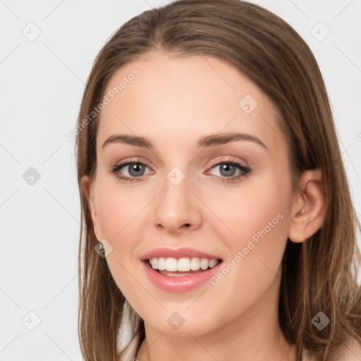 Joyful white young-adult female with long  brown hair and grey eyes