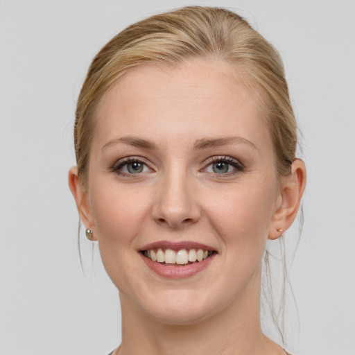 Joyful white young-adult female with medium  brown hair and blue eyes