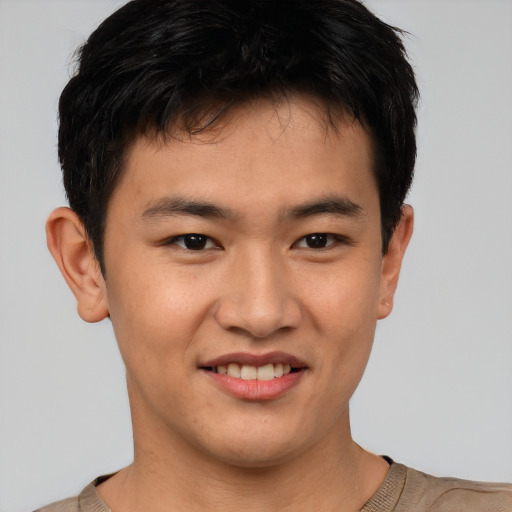 Joyful asian young-adult male with short  brown hair and brown eyes