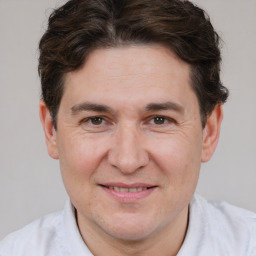 Joyful white adult male with short  brown hair and brown eyes