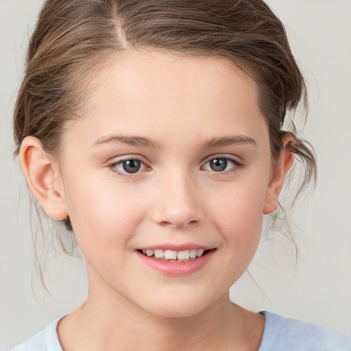 Joyful white child female with medium  brown hair and brown eyes