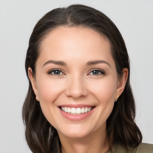 Joyful white young-adult female with medium  brown hair and brown eyes