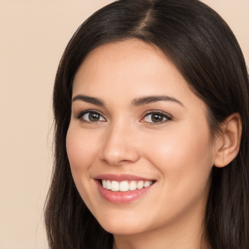 Joyful white young-adult female with long  brown hair and brown eyes