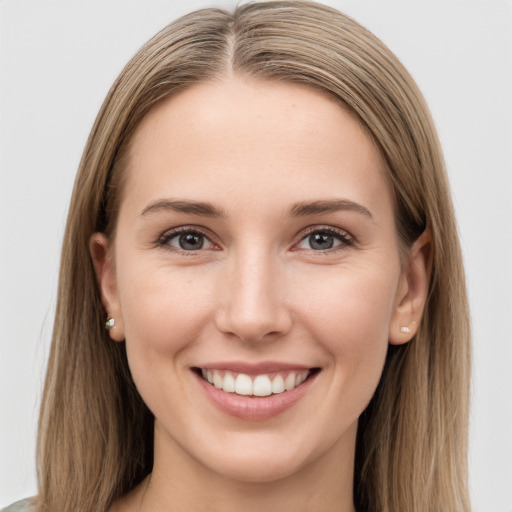 Joyful white young-adult female with long  brown hair and grey eyes