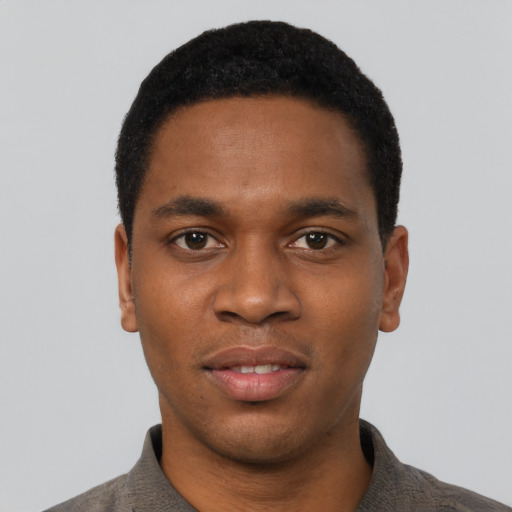 Joyful black young-adult male with short  black hair and brown eyes