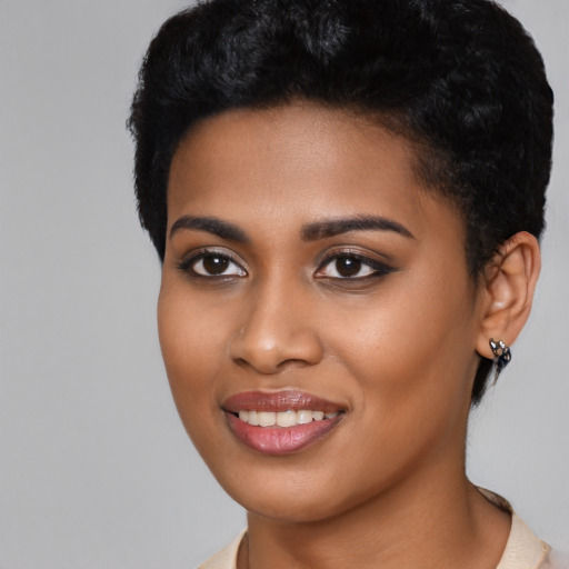 Joyful black young-adult female with short  black hair and brown eyes