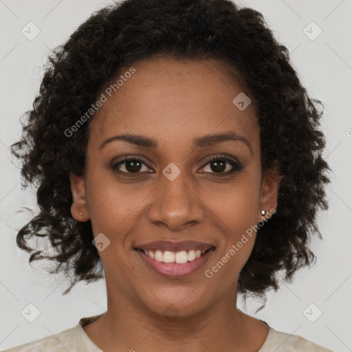 Joyful black young-adult female with short  brown hair and brown eyes