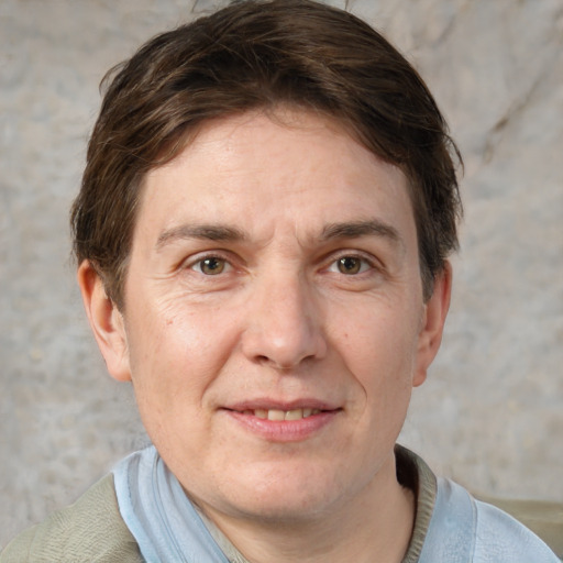 Joyful white adult male with short  brown hair and grey eyes