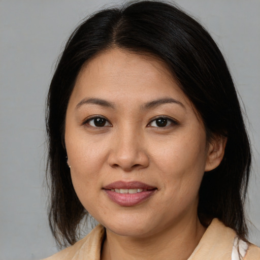 Joyful asian young-adult female with medium  brown hair and brown eyes