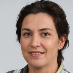 Joyful white adult female with medium  brown hair and brown eyes