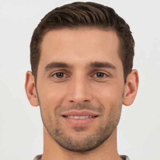 Joyful white young-adult male with short  brown hair and brown eyes