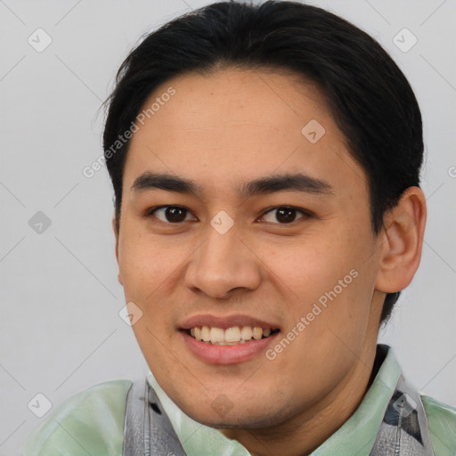 Joyful asian young-adult male with short  brown hair and brown eyes