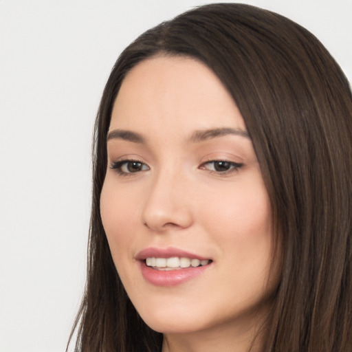 Joyful white young-adult female with long  black hair and brown eyes