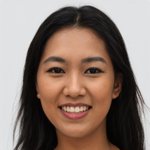 Joyful asian young-adult female with long  brown hair and brown eyes