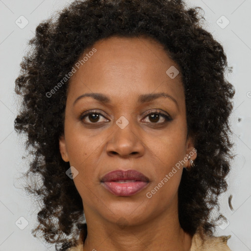 Joyful black adult female with medium  brown hair and brown eyes