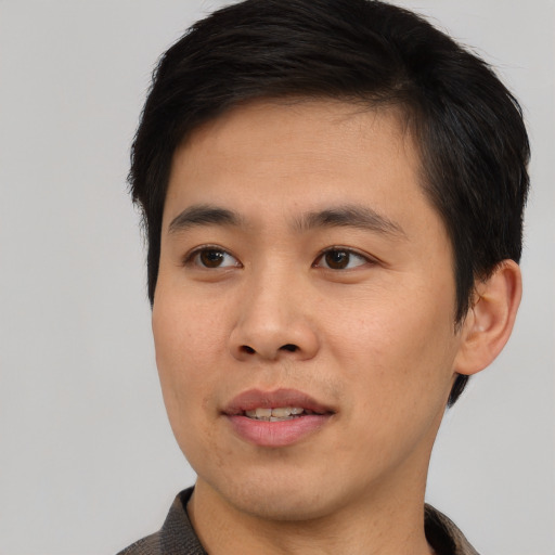 Joyful asian young-adult male with short  brown hair and brown eyes