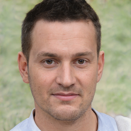 Joyful white adult male with short  brown hair and brown eyes