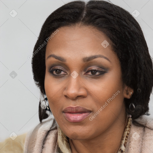 Joyful black young-adult female with long  brown hair and brown eyes