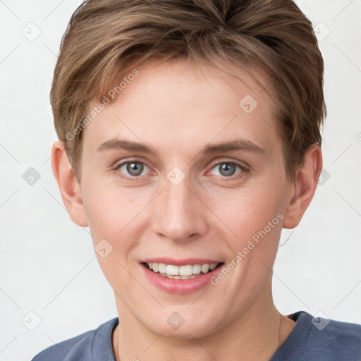 Joyful white young-adult female with short  brown hair and grey eyes