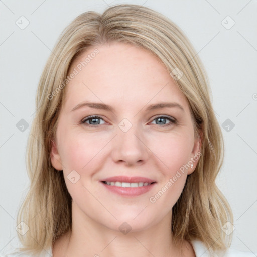 Joyful white young-adult female with long  brown hair and blue eyes