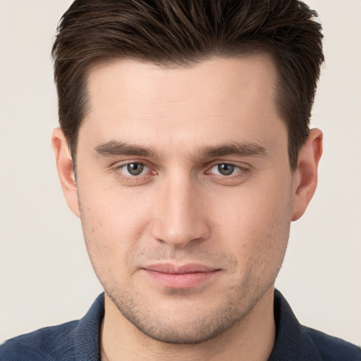 Joyful white young-adult male with short  brown hair and brown eyes