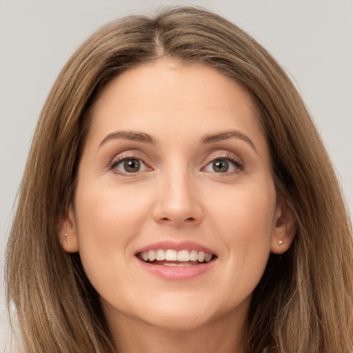 Joyful white young-adult female with long  brown hair and brown eyes