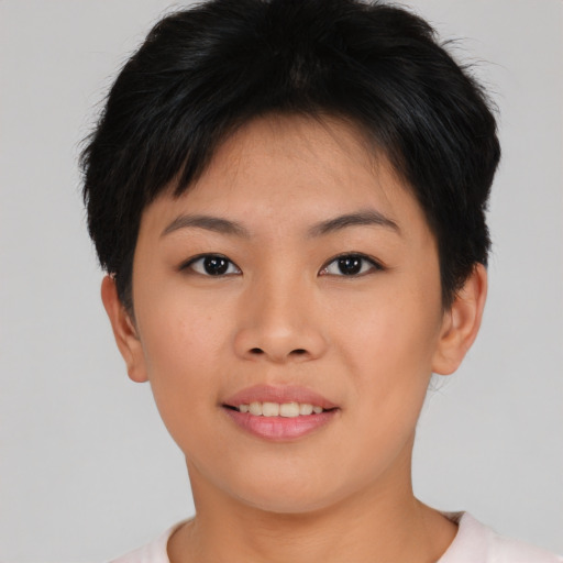 Joyful asian young-adult female with short  brown hair and brown eyes