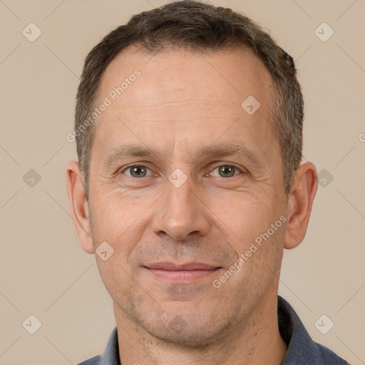 Joyful white adult male with short  brown hair and brown eyes