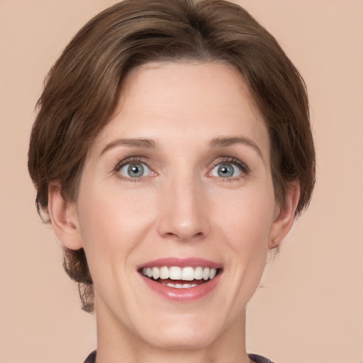 Joyful white young-adult female with medium  brown hair and grey eyes