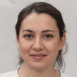 Joyful white adult female with medium  brown hair and brown eyes