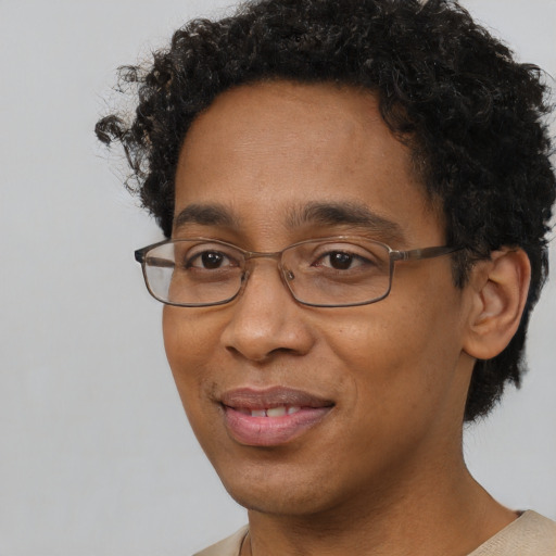 Joyful black adult male with short  brown hair and brown eyes